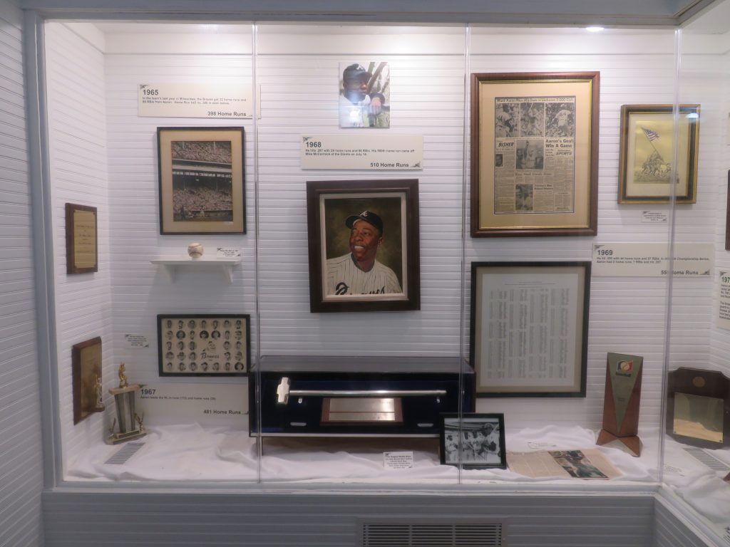 Exhibit showing Hank Aaron memorabilia from his playing career during the 1960s.