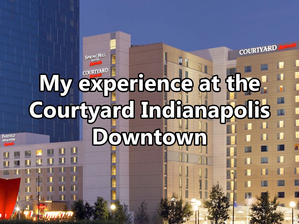 Overview of multiple 12-story buildings with text overlaying image that says "My experience at the Courtyard Indianapolis Downtown."