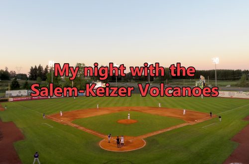 Aerial overview of a baseball field with an interstate in the background and text overlaying the image that says "My night with the Salem-Keizer Volcanoes."