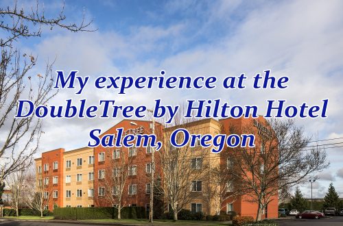 Exterior overview of a large hotel building with text overlaying it that says, "My experience at the DoubleTree by Hilton Hotel Salem, Oregon."