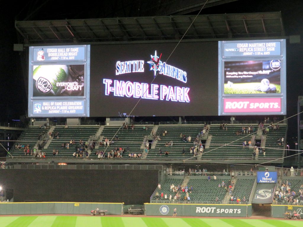Text saying "Seattle Mariners" and "T-Mobile Park" rotates on a large videoboard.