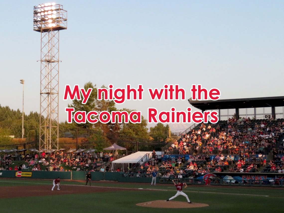 View of a baseball stadium showing a pitcher on the mound with a grandstand behind him and Mount Rainier in the distance. Text overlaying the image says "My night with the Tacoma Rainiers."