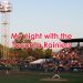 View of a baseball stadium showing a pitcher on the mound with a grandstand behind him and Mount Rainier in the distance. Text overlaying the image says "My night with the Tacoma Rainiers."