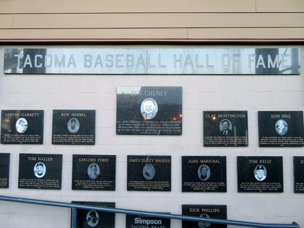 Wall with large granite plaque that says "Tacoma Baseball Hall of Fame" with several smaller plaques with individual names and cameos of people in the hall.