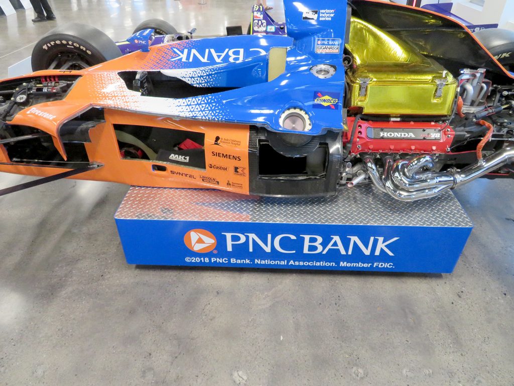An Indy car cut away on the left-hand side showing the interior of the vehicle.