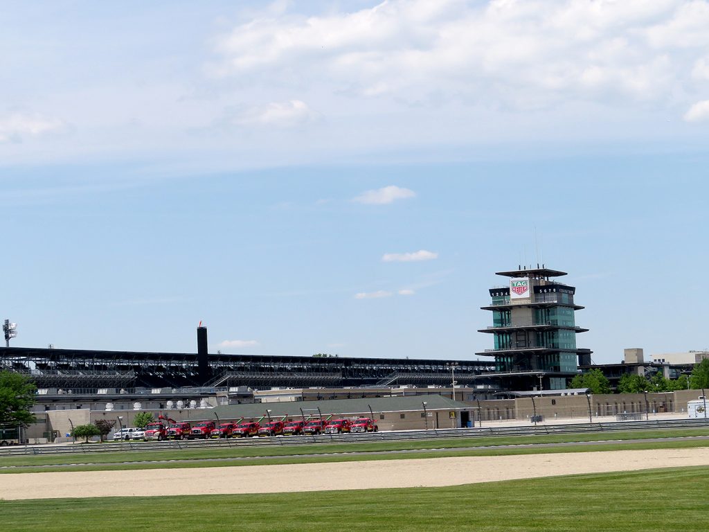 Overview of a four-tier pagoda and the back stretch of Indianapolis Motor Speedway.