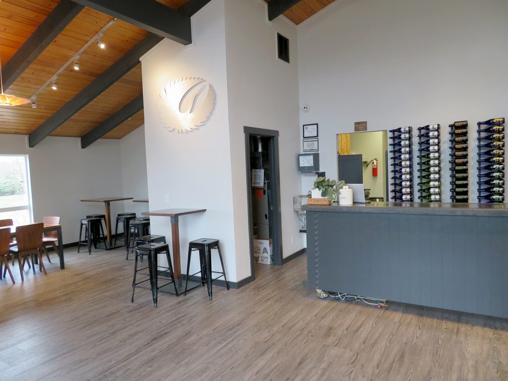 Overview of a counter on the right and seating to the left in the tasting room at SakéOne.