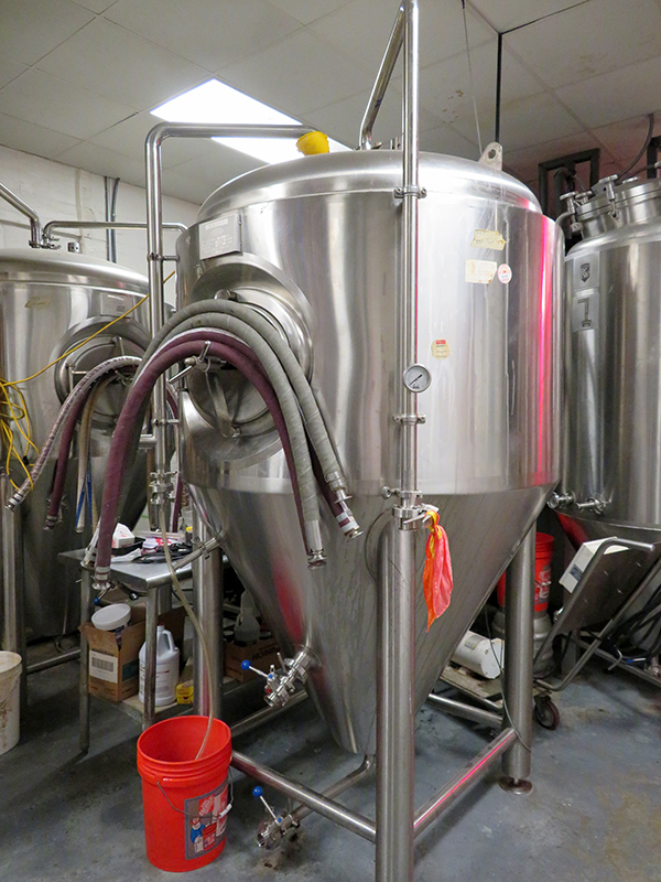 Collection of small stainless steel fermentation tanks.